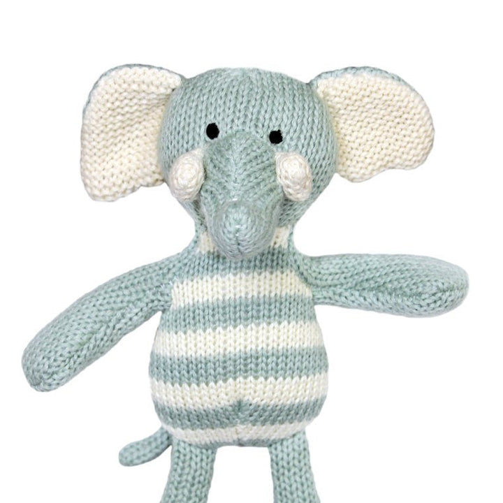 Knitted toy elephant with striped pattern laying flat on a white background